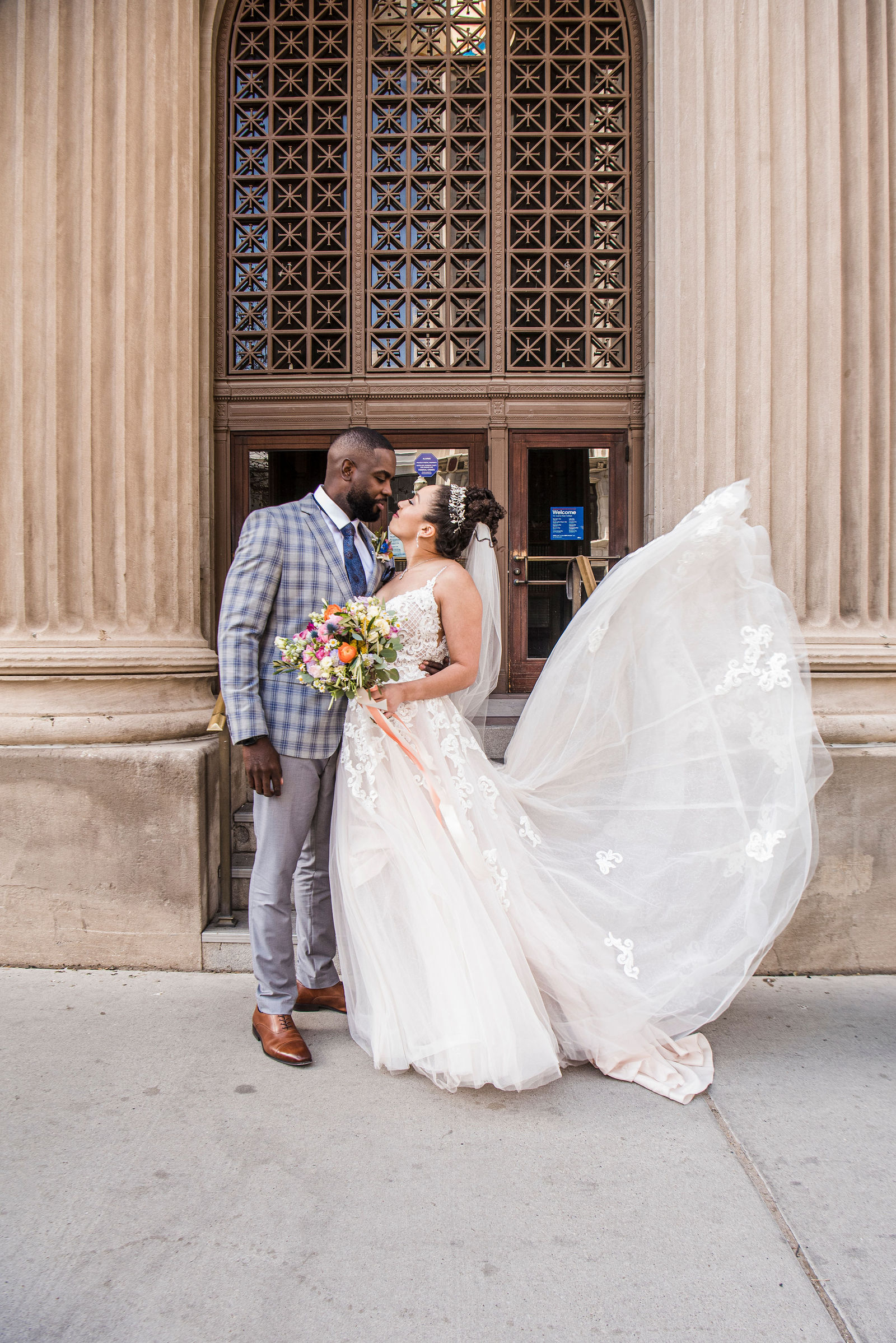 A newlywed couple pose outside of the courthouse in El Paso, Texas